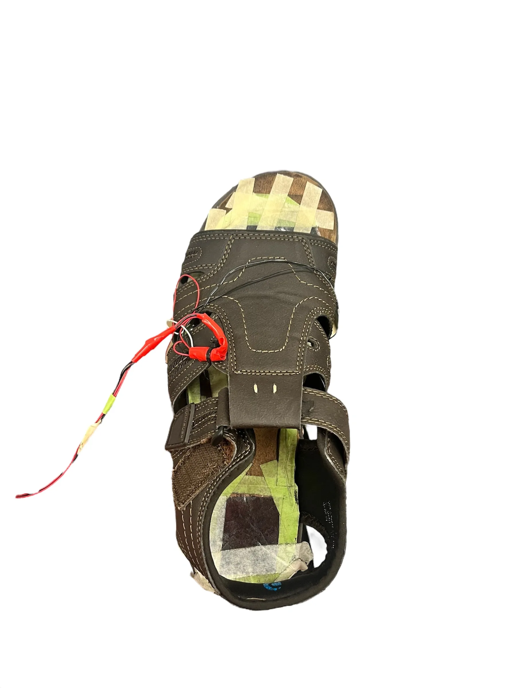 Closeup of an instrumented sandal with wired force sensors used for gait data collection