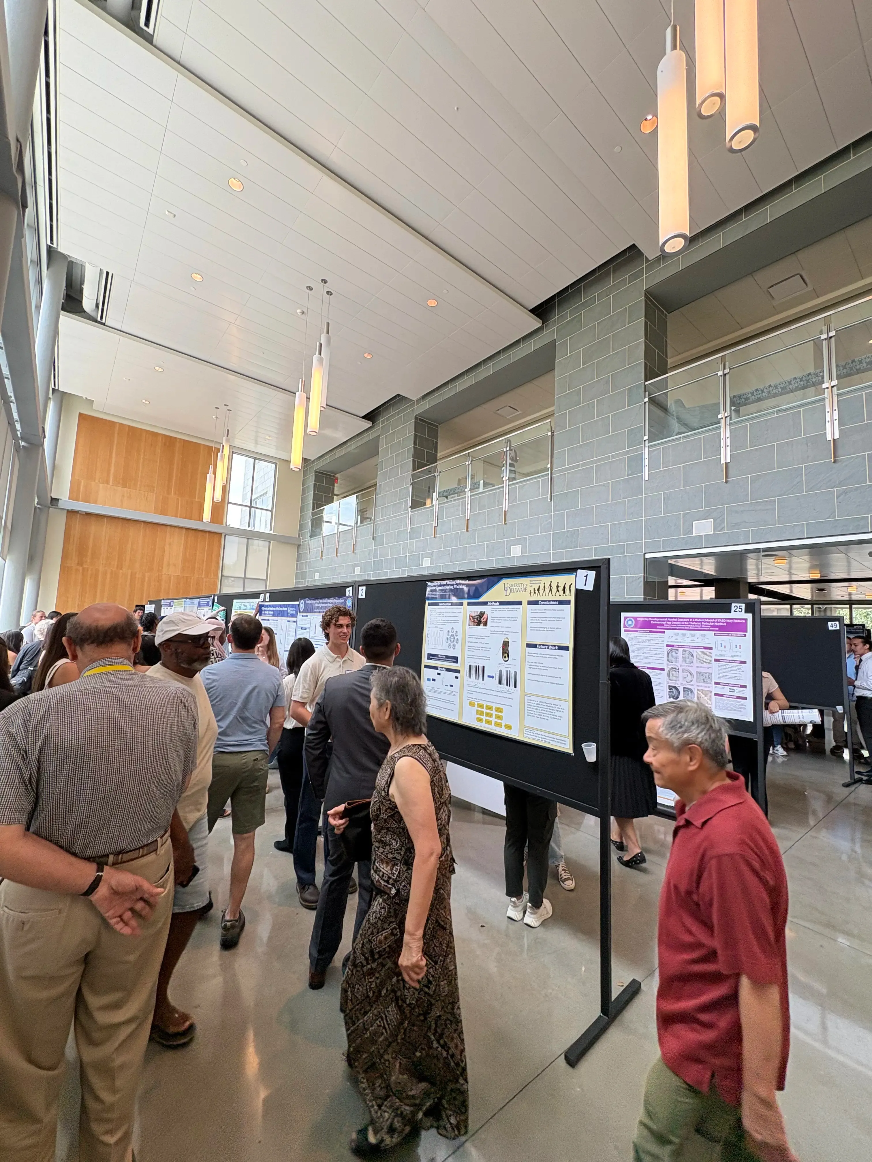 Wide shot of the poster presentation session at a University of Delaware research symposium